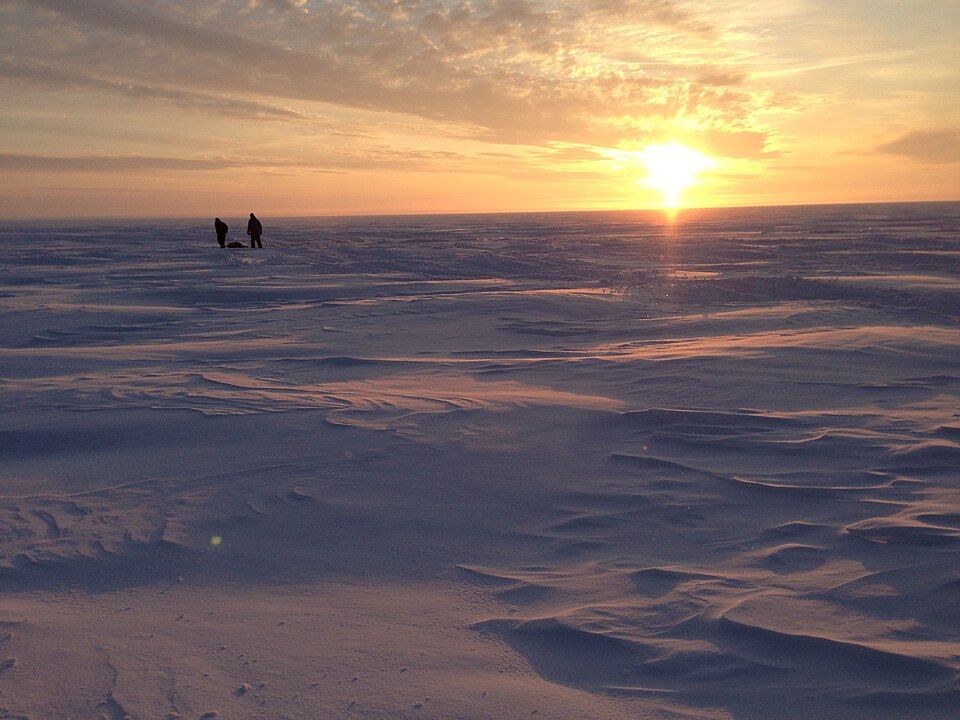 people ice fishing on a frozen Canadian lake