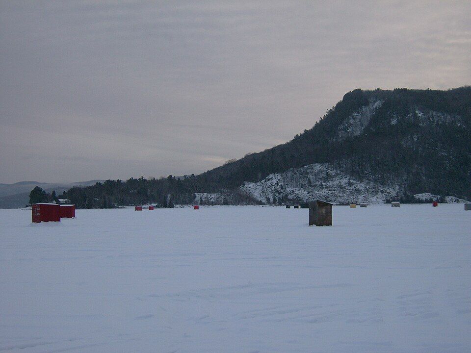 ice fishing huts across frozen lake