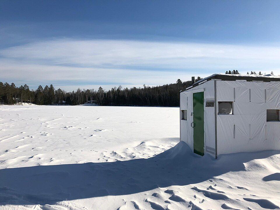 ice fishing hut on frozen lake